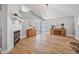 Living room featuring hardwood floors, a fireplace, and a high vaulted ceiling with stylish lighting at 3889 Biscayne Dr, Winter Springs, FL 32708