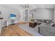 Open living room featuring hardwood floors, a gray sectional sofa, and natural light at 3889 Biscayne Dr, Winter Springs, FL 32708