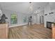 Bright living room featuring hardwood floors, a fireplace, and natural light from large windows at 3889 Biscayne Dr, Winter Springs, FL 32708