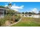 Picturesque backyard view of a serene pond and lush landscaping, offering a peaceful outdoor setting at 4219 Lillian Hall Ln, Orlando, FL 32812