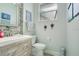 Modern bathroom featuring a wooden vanity, decorative mirror and neutral colors at 4219 Lillian Hall Ln, Orlando, FL 32812