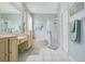 Well-lit bathroom with a tub, shower, and double sink vanity at 4219 Lillian Hall Ln, Orlando, FL 32812