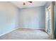 Empty bedroom with neutral carpet and blue walls and a large window at 4219 Lillian Hall Ln, Orlando, FL 32812