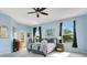Bright bedroom with a ceiling fan and light blue walls and carpet at 4219 Lillian Hall Ln, Orlando, FL 32812