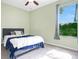 Neutral toned bedroom with light green walls and plenty of natural light at 4219 Lillian Hall Ln, Orlando, FL 32812