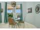 Cozy breakfast nook featuring a glass-top table, wicker chairs, and views of the outdoor area at 4219 Lillian Hall Ln, Orlando, FL 32812
