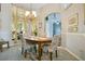 Formal dining room with wainscoting, chandelier, and a view into another living space at 4219 Lillian Hall Ln, Orlando, FL 32812