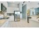 Efficient kitchen with stainless steel appliances, white cabinets, and tiled backsplash at 4219 Lillian Hall Ln, Orlando, FL 32812