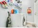 A well-equipped laundry room with a washer, dryer, storage shelves, and a vacuum cleaner for efficient cleaning at 4219 Lillian Hall Ln, Orlando, FL 32812