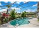 Private screened-in pool featuring lush tropical landscaping, providing a serene and secluded outdoor retreat at 4219 Lillian Hall Ln, Orlando, FL 32812