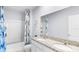 Clean bathroom with double vanity, granite countertops, tub, shower, and blue seashell-themed decor at 4622 Barberry Ave, Lakeland, FL 33811