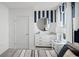 Charming bedroom with striped accent wall, comfortable bed, and stylish nautical decorations at 4622 Barberry Ave, Lakeland, FL 33811
