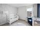 Charming Bedroom with a white crib, stylish accent wall, and a comfortable seating area at 4622 Barberry Ave, Lakeland, FL 33811