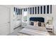Charming bedroom with striped accent wall, comfortable bed, and stylish nautical decorations at 4622 Barberry Ave, Lakeland, FL 33811