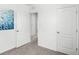Bright bedroom with neutral carpet, white walls, modern baseboards, and doorways leading to other rooms at 4622 Barberry Ave, Lakeland, FL 33811