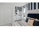 Charming bedroom with striped accent wall, comfortable bed, and stylish nautical decorations at 4622 Barberry Ave, Lakeland, FL 33811