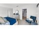 Comfortable bedroom boasts blue accents, grey dresser and carpet, and a modern chair at 4622 Barberry Ave, Lakeland, FL 33811