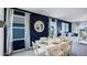 Charming dining area with a white dining table, elegant mirror, and stylish navy blue accent wall with white trim at 4622 Barberry Ave, Lakeland, FL 33811