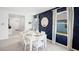 Bright dining room features an elegant white table set, stylish mirror, and a decorative blue accent wall at 4622 Barberry Ave, Lakeland, FL 33811