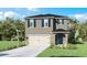 Inviting two-story home features a two car garage, stone accents, and a well manicured front yard at 4622 Barberry Ave, Lakeland, FL 33811