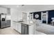 Open-concept kitchen and dining area with stainless steel appliances, island, and modern decor at 4622 Barberry Ave, Lakeland, FL 33811