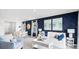 Open-concept living space with decorative blue accent wall connecting the living room, dining area, and kitchen at 4622 Barberry Ave, Lakeland, FL 33811