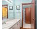 Well-lit bathroom with white cabinets and a full shower and toilet, accented by blue walls at 516 Orange Dr # 22, Altamonte Springs, FL 32701