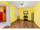 Well-lit bedroom with wood floors, featuring bright yellow walls, ample natural light and tasteful decor at 516 Orange Dr # 22, Altamonte Springs, FL 32701