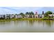 Lakeside condos with large windows surrounded by lush grass and palm trees, reflecting in the water at 516 Orange Dr # 22, Altamonte Springs, FL 32701