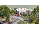 Exterior of lakeside condos featuring mature trees and a spacious parking lot at 516 Orange Dr # 22, Altamonte Springs, FL 32701