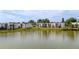 Lakeside condos with large windows surrounded by lush grass and palm trees, reflecting in the water at 516 Orange Dr # 22, Altamonte Springs, FL 32701