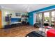 Bright living room with hard floors, entertainment center, and sliding glass doors to the outside at 516 Orange Dr # 22, Altamonte Springs, FL 32701