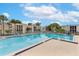 Community pool surrounded by lounge chairs and well-maintained landscaping at 516 Orange Dr # 22, Altamonte Springs, FL 32701