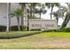 Sign for Royal Arms Condominium with manicured landscaping and palm trees at 516 Orange Dr # 22, Altamonte Springs, FL 32701