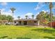 Expansive backyard featuring a patio with outdoor seating and lush green lawn at 5162 Tellson Pl, Orlando, FL 32812