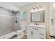 Bathroom features a walk-in shower with gray tile, a white vanity, and modern fixtures at 5162 Tellson Pl, Orlando, FL 32812