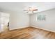 Empty bedroom with light walls, wood-look floors, a ceiling fan, and a window at 5162 Tellson Pl, Orlando, FL 32812