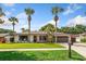 Charming single-story home with lush landscaping and a well-manicured lawn and mature palm trees at 5162 Tellson Pl, Orlando, FL 32812
