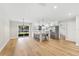 Open-concept room with an island, hardwood floors, stainless steel appliances, and lots of natural light at 5162 Tellson Pl, Orlando, FL 32812