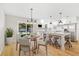 Bright kitchen boasts white cabinets, stainless steel appliances, island with seating, and an adjacent dining nook at 5162 Tellson Pl, Orlando, FL 32812