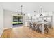 Bright kitchen boasts white cabinets, stainless steel appliances, and island with seating at 5162 Tellson Pl, Orlando, FL 32812