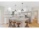 Kitchen features white cabinets, granite countertops, stainless steel appliances and a large island with seating at 5162 Tellson Pl, Orlando, FL 32812