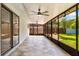 An empty covered lanai featuring tile flooring, a ceiling fan, and backyard views at 5162 Tellson Pl, Orlando, FL 32812