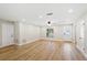 Large room that has hardwood floors, neutral colors, lots of natural light, and multiple doors at 5162 Tellson Pl, Orlando, FL 32812