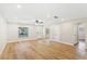 Spacious room featuring hardwood floors, neutral colors, and multiple windows for lots of natural light at 5162 Tellson Pl, Orlando, FL 32812