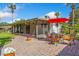 Brick patio with outdoor furniture, an umbrella, and a view of the screened lanai at 5162 Tellson Pl, Orlando, FL 32812
