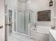 Bathroom featuring a tub and shower with glass doors at 525 Hardwood Cir, Orlando, FL 32828
