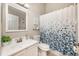 Well-lit bathroom featuring a vanity, mirror, and tub with a shower curtain at 525 Hardwood Cir, Orlando, FL 32828