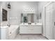 Bathroom with double sinks, vanity, and a separate tub at 525 Hardwood Cir, Orlando, FL 32828