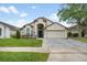 Charming single-story home with a neutral color scheme and a paver driveway at 525 Hardwood Cir, Orlando, FL 32828